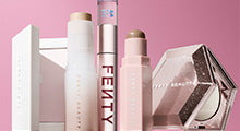 Product shot of Fenty Beauty products on a pink background.