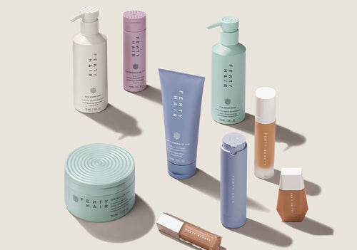 Fenty Hair collection, Fenty Skin Hydra Vizor SPF moisturizer, Fenty Beauty foundations, and Fenty Beauty Gloss Bomb Universal Lip Luminizer products standing up on a cream background. Fenty Hair collection, Fenty Skin Hydra Vizor SPF moisturizer, Fenty Beauty foundations, and Fenty Beauty Gloss Bomb Universal Lip Luminizer products standing up on a cream background.