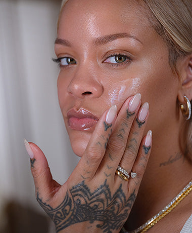 Rihanna applying Hydra Vizor Sunscreen to a clean face.